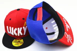 Detail of kids snapback hat with LUCKY embroidery and adjustable plastic back strap