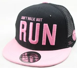 Detail of black and pink snapback trucker hat with embroidered slogan and mesh back