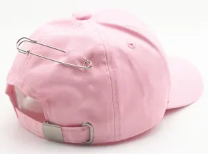 Pink cotton baseball cap featuring silver metal pin detail and adjustable rear buckle