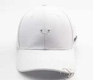 Detail of white cotton baseball cap featuring three metal rings and side embroidery