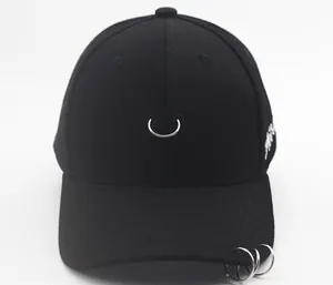 Close-up of black cotton baseball cap featuring silver metal rings and side embroidery
