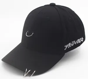 Close-up of black cotton baseball cap with metal rings and white Japanese embroidery