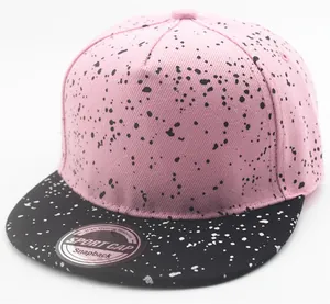 Detail view of pink and black snapback hat with stylish contrast paint splatter patterns