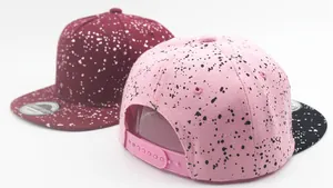 Detail view of splatter pattern hip-hop caps with adjustable plastic snapback closure