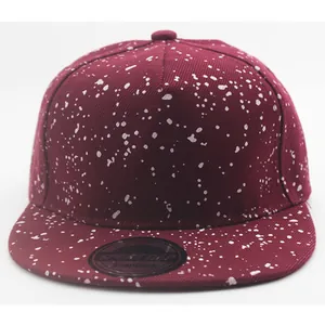 Kid's snapback cap in burgundy with white paint splatter pattern for casual outdoor wear