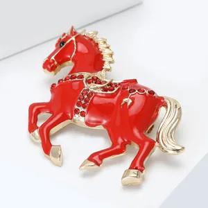 Macro view of horse brooch featuring red enamel finish and sparkling crystal accents