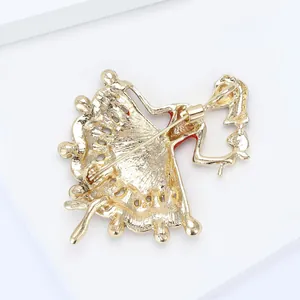 Detail of golden ballerina brooch back showing pin clasp and textured metal finish