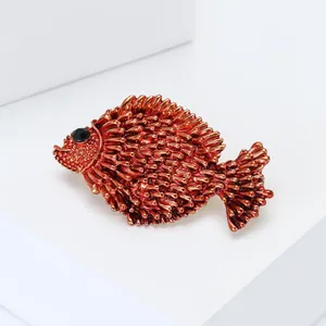 Detail of fish brooch with bronze metallic spikes and a black rhinestone eye detail