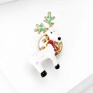 Cute Christmas reindeer brooch with white sequin body and green antlers on white background