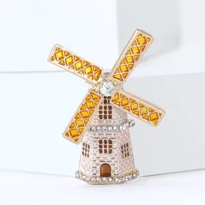 Exquisite golden windmill brooch with vibrant yellow crystals and sparkling white rhinestones