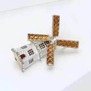 Macro view of lighthouse windmill brooch with enamel finish and sparkling crystals