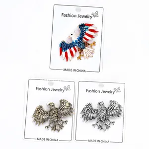 Detailed set of three eagle brooches in colorful enamel, antique gold, and silver finishes