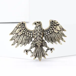 Macro detail of vintage eagle brooch showing antique gold wings and feather texture