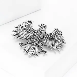 Detailed view of the vintage silver eagle brooch with intricate feather texture carving