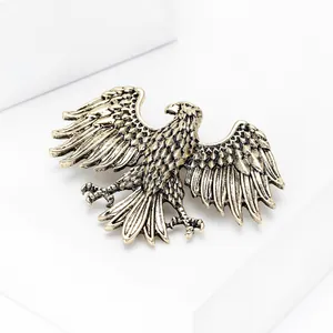 Detailed view of alloy eagle brooch with antique gold finish and textured wing feathers