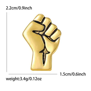 Polished gold fist brooch pin with black engraved outlines for suits and accessories