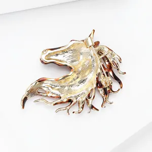 Macro shot of horse head brooch back showing secure metal pin clasp and gold finish