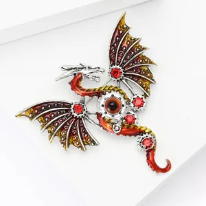 Detailed view of steampunk dragon brooch with red enamel and gear-inspired silver wings