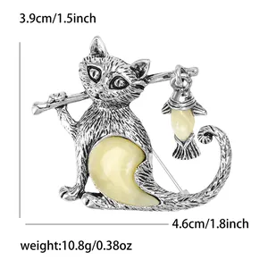 Vintage style cat brooch with fishing rod design and yellow crystals for fashion outfits