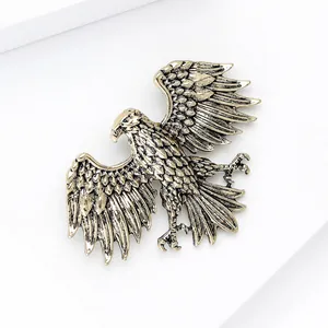 Detailed view of an antique gold eagle brooch with intricate textured wing feathers