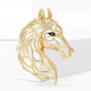 Minimalist golden horse head brooch with hollow texture and black eye on white pedestal