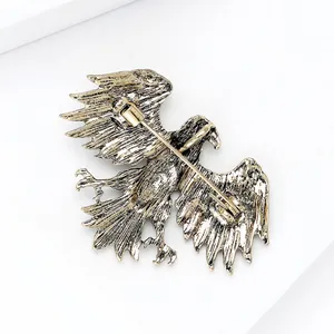 Detail of eagle brooch back with secure pin clasp and antique gold feather textures