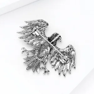 Detailed back view of silver eagle brooch showing the secure pin clasp and feather texture