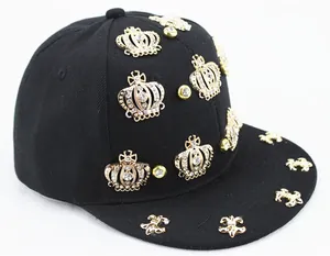 Punk style black snapback cap with gold crown emblems and sparkling crystal studs