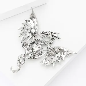 Detail view of the silver dragon brooch back showing intricate floral textures and pin clasp