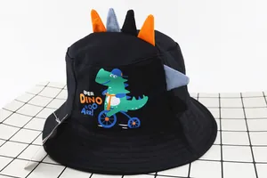 Detail of kids black bucket hat with 3D dinosaur spikes and cartoon bicycle graphics
