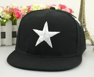 Detail of white star embroidery on a black snapback flat brim hip-hop baseball cap