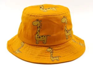 Close-up of bright yellow cotton bucket hat with cute cartoon giraffe print patterns