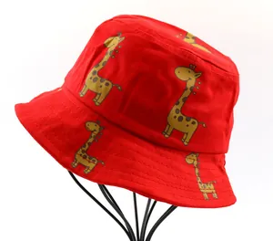 Close-up of red cotton bucket hat with yellow giraffe print on a metal display stand