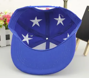 Macro shot of blue kids baseball cap interior showing white star embroidery and snapback strap