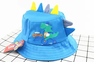 Close-up of blue cotton bucket hat for kids with cartoon dinosaur pattern and 3D fin details