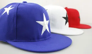 Close-up of three kids snapback caps with star embroidery in blue, white and red colors