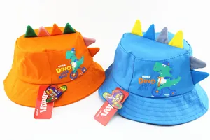 Close-up of kids cartoon dinosaur sun hat featuring 3D decorative fins and cotton fabric