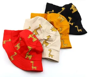 Flat lay of foldable kids giraffe print sun hats in red, beige, yellow and black colors