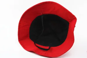 Detail view of red kids bucket hat with black lining, stitching, and elastic chin strap