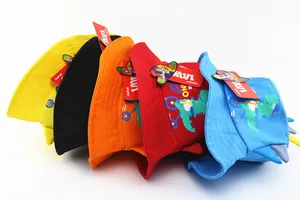 Detail view of colorful kids sun hats with cute dinosaur prints and 3D horns
