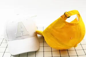Detail of cotton baseball cap with letter A embroidery and adjustable metal buckle back