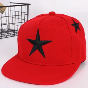 Flat brim red snapback hat with black star embroidery in a six-panel cotton twill design