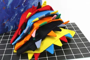 Detail view of colorful cotton bucket hats for kids with 3D cartoon dinosaur spikes