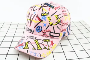 Detailed graffiti print on pink baseball cap with ROCK and ART lettering design