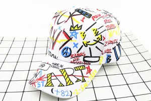 Close-up of graffiti print on white canvas baseball cap with colorful art patterns