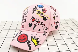 Detail of pink cotton baseball cap with colorful street graffiti and crown prints