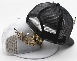 Detail of kids trucker hats featuring golden metal wings and punk style rivet accents