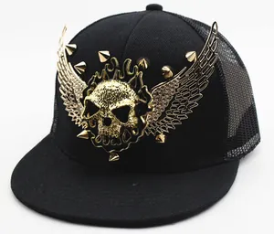 Detail of black snapback hat with 3D gold skull, winged base and metallic studs