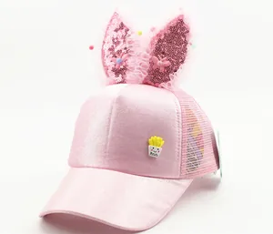 Detailed view of pink mesh kids cap with sequin ears and cute potato fry badge