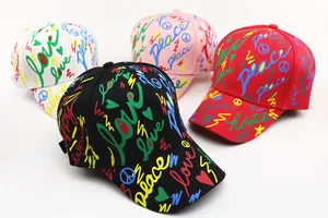 Detailed view of colorful graffiti prints on multi-color cotton baseball caps for kids
